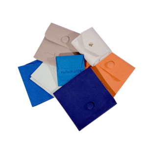 Assorted custom jewelry bags in various colors and textures with snap or flap closures, featuring logo printing for brand presentation and luxury packaging.