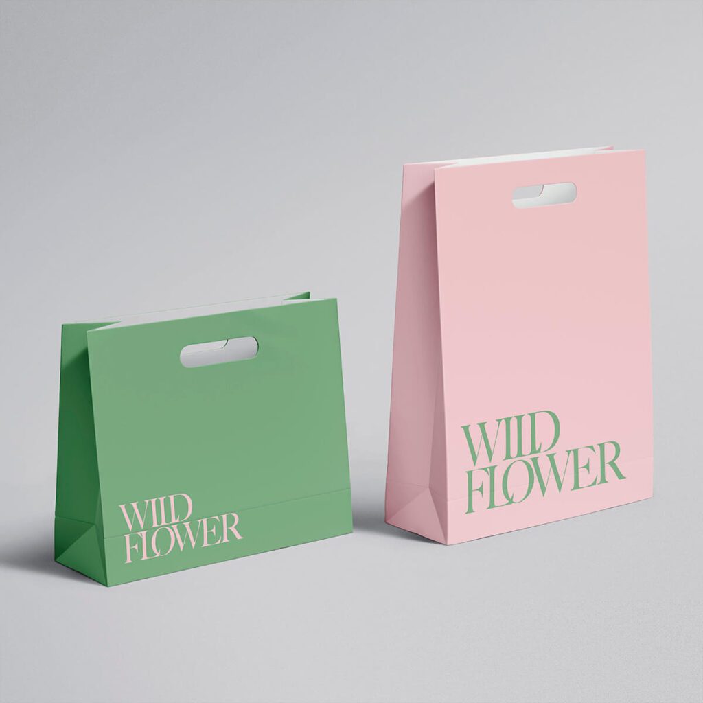 Minimalist green and pink paper bags with die cut handles, custom retail packaging for fashion and boutiques