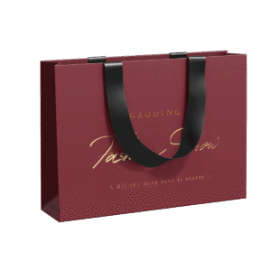 Custom clothing packaging bag with gold foil logo and black ribbon handles – ideal for fashion brands seeking a luxurious retail look.
