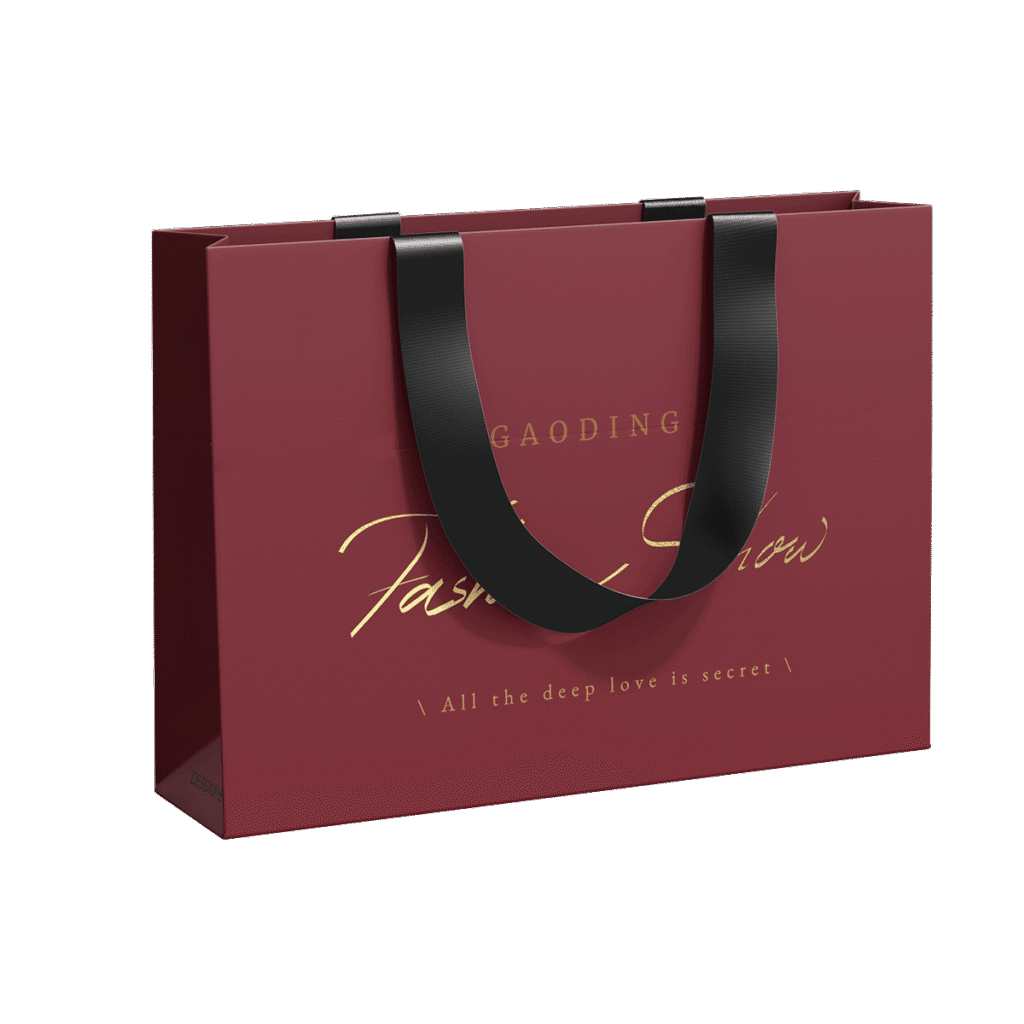 Custom clothing packaging bag with gold foil logo and black ribbon handles – ideal for fashion brands seeking a luxurious retail look.