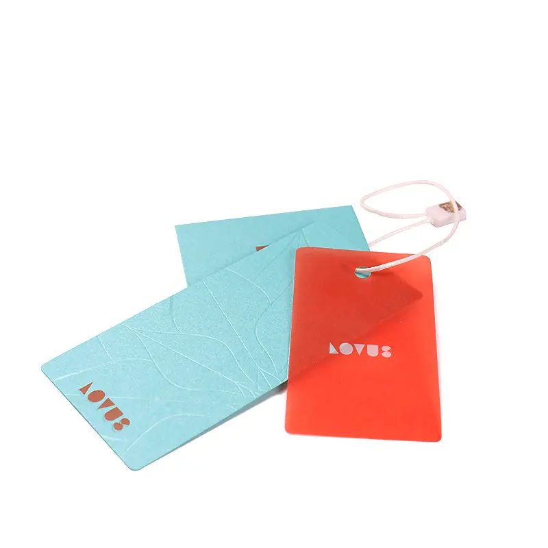 Custom blue and red apparel hang tags with logo cutouts and string for branded clothing and retail packaging.
